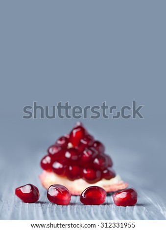 Photo poster natural pomegranate seeds. Photography design fruit postcard template, healthy food concept. Closeup part of pomegranate. gray soft background. Shallow depth of field. copy space.