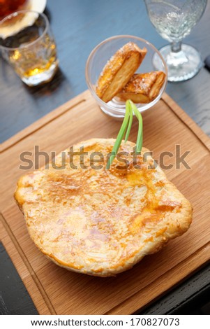 Meat pie on table in pub, men\'s food