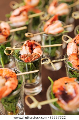 Tasty appetizer of shrimps and arugula on restaurant table