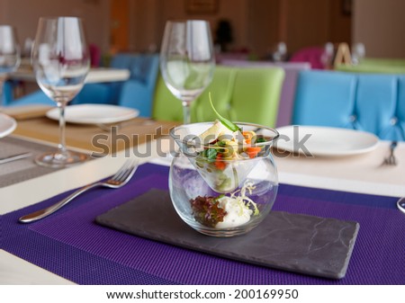 Russian salad in creative serving on restaurant table