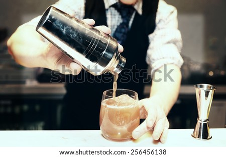 Bartender is making cocktail at bar counter