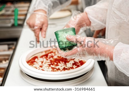 Culinary student is cooking pizza, toned image