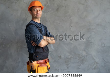 Similar – Image, Stock Photo Smiling workman in denim overall looking at camera