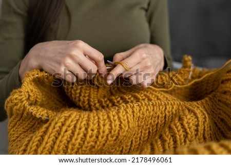 Image, Stock Photo Close-up of a knitted piece with wooden knitting needles and ball of wool