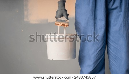 Similar – Image, Stock Photo painter working with paint roller to paint the wall of a room. do it yourself concept image