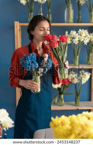 Similar – Image, Stock Photo Woman smells red tulips