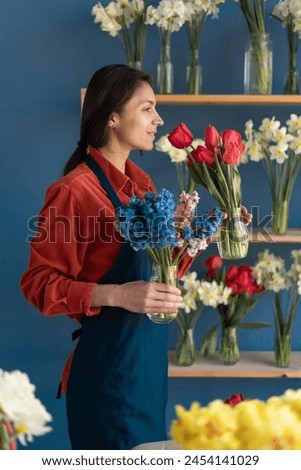 Similar – Image, Stock Photo Woman smells red tulips