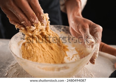 Similar – Image, Stock Photo Cook kneading dough with hand on table