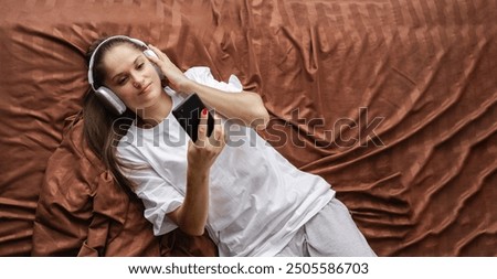 Similar – Image, Stock Photo carefree brunette woman lying on the floor laughing