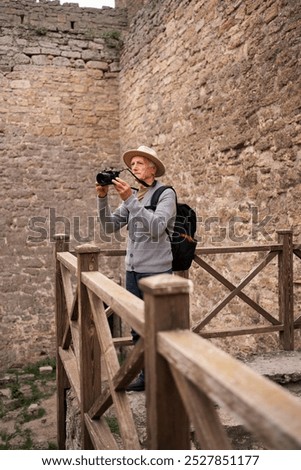 Similar – Image, Stock Photo Senior wanderer standing on hill in mountains