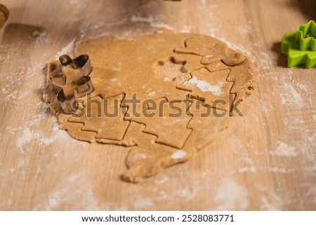 Similar – Image, Stock Photo Gingerbread cookies dough cut in different shapes on a blue table. Baking Christmas cookies