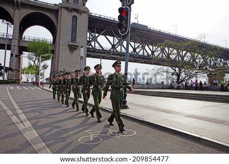WUHAN, CHINA - APRIL 15: Squad marches on a road near the Changjiang Bridge on April 15, 2013 in Wuhan, China