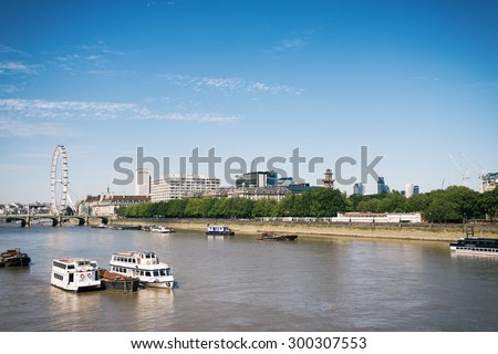 LONDON UK - JULY 10: London Eye and the River Thames with its boats on 10 July 2015