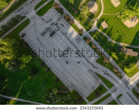 Similar – Image, Stock Photo Two asphalt parking spaces in front of a colourful concrete wall and the shadow of a railing