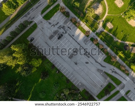 Similar – Image, Stock Photo Two asphalt parking spaces in front of a colourful concrete wall and the shadow of a railing