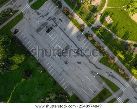 Similar – Image, Stock Photo Two asphalt parking spaces in front of a colourful concrete wall and the shadow of a railing