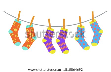Three pairs of colorful children socks drying on the clothesline. Vector illustration in flat style
