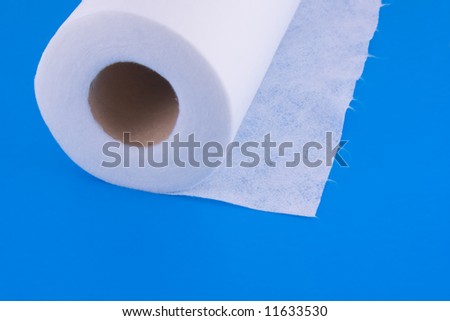 roller towel made of nonwoven fabric with tear-off fibers isolated over blue