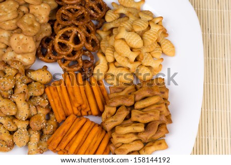 range of salty snacks lying on a white plate