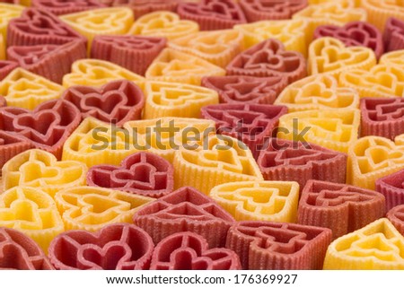 pasta in the form of hearts in two colors fill the entire frame