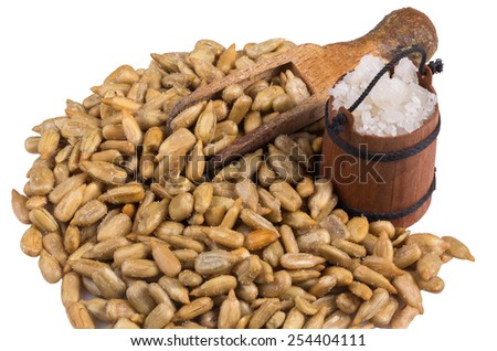 salted sunflower seeds with a wooden spoon and a bucket with salt