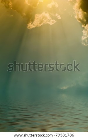 Rays of the sun through dark clouds over the water, the atmospheric background