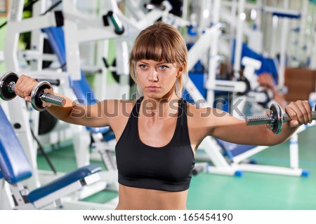 woman goes in for sports in sport hall