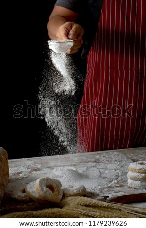 Similar – Image, Stock Photo Person sprinkling icing sugar over on cookies