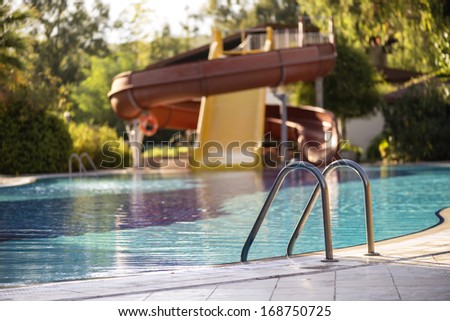 Swimming pool ; focus on pool ladders background with pool slides