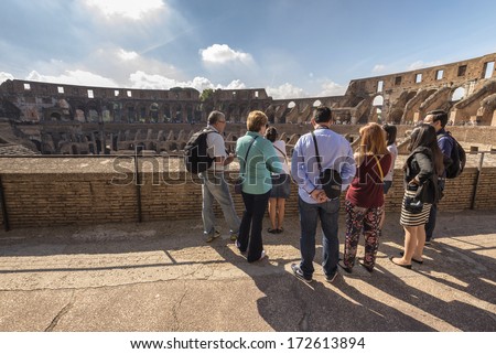ROME, ITALY - SEPTEMBER 25 : Interior of Colosseum ; tourist group listens guided tour on September 25, 2013 in Rome Italy.