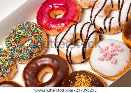 Bunch of donuts in white box.