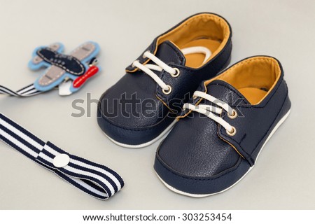A pair of baby shoes with a toy plane to represent new born baby and many parenting concepts.