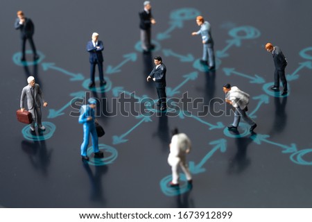 Social distancing, keep distance in public society people to protect COVID-19 coronavirus outbreak spreading concept, businessmen miniature keep distance away in the meeting with distant measure.