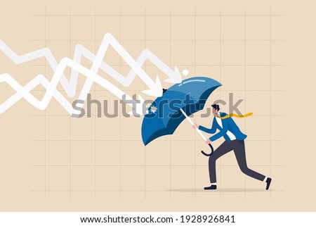 Protection or defensive stock in economy crisis or market crash, business resilient to survive difficulty or insurance concept, businessman holding umbrella to cover and protect from downturn arrow.