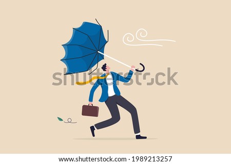 Business difficulty or obstacle in economic crisis, mistake or accident causing problem or failure, depressed and anxiety concept, frustrated businessman holding broken umbrella in strong wind storm.