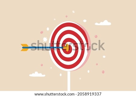 Aiming for children education target, parenting or kid knowledge or skill, humor business target or achievement concept, bow arrow children toy with suction cup hit sweet lollipop bullseye target. Photo stock © 