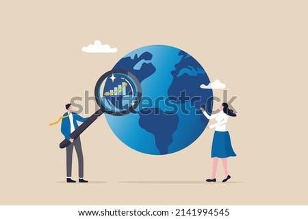 World economic analysis, global investment or international business opportunity research, forecast and analyze financial information concept, businessman with magnifier on globe with chart and graph.