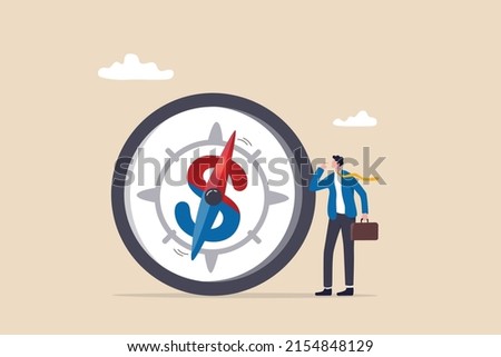 Economic direction or investment trend, financial indicator, inflation or interest rate direction, recession or growth concept, businessman investor looking at compass with dollar sign direction. Foto d'archivio © 