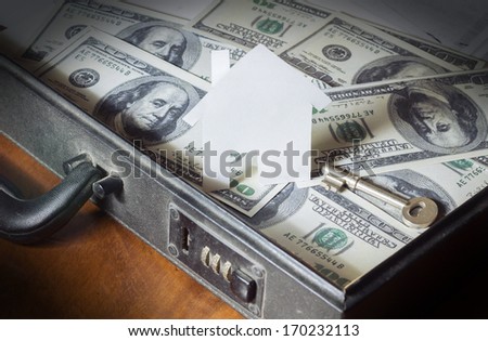 Money for house,Money and house model in briefcase.