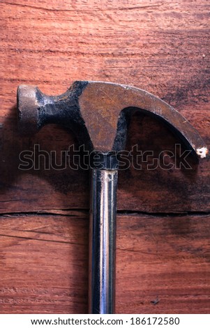 Top view of hammer on wood table,still life.