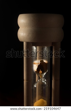 Time of hopeless,surreal sad people in hourglass.