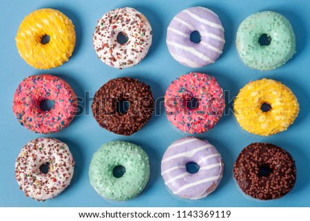 Similar – Image, Stock Photo Donuts in a row on blue background. Homemade ring doughnuts, top view