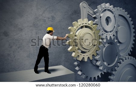 Businessman turning a gear business system