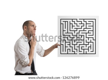 Businessman looking for a solution of a maze