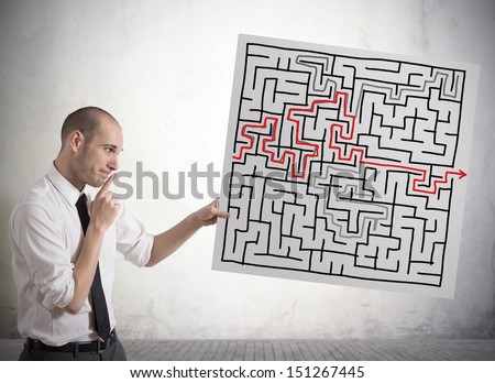 Businessman finding solution for the maze
