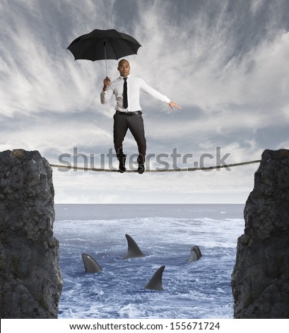 Insurance concept with businessman on a rope and shark in the sea