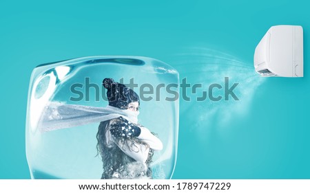 Woman frozen in an ice cube under the air jet of an air conditioner on cyan background Stock foto © 