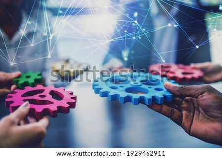 Group of people connect single colored cogwheels to make a gear. Teamwork, partnership and integration concept.