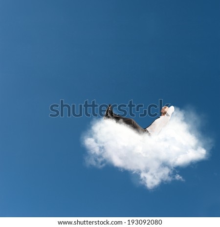 Concept of relax of a businessman on a cloud