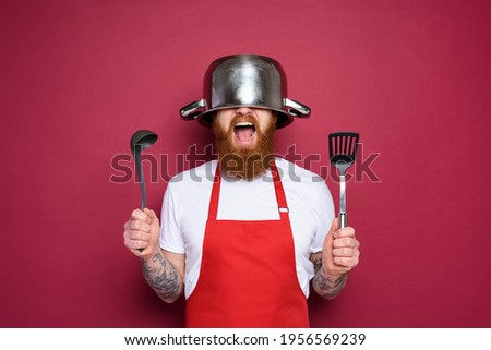 Man chef is ready to fight in the kitchen. burgundies background Imagine de stoc © 
